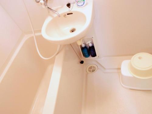 a bathroom with a sink and a toilet at STAY IN SUMUKA Kokusai Street in Naha