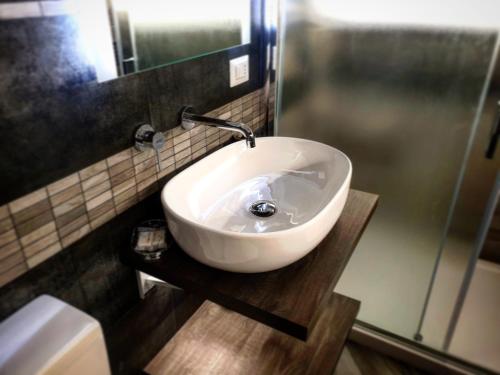 a white sink in a bathroom with a shower at Central Campobasso in Campobasso