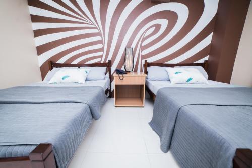 Postel nebo postele na pokoji v ubytování JSB Suites