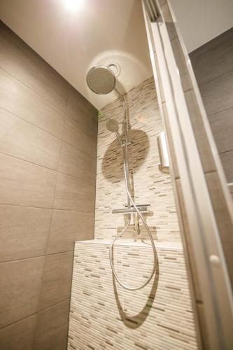 a shower with a shower head in a bathroom at Trendy Design 55m2 Apartment with Balcony - DB6B in Den Bosch