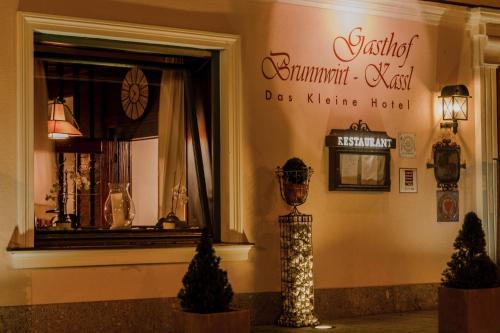 a store front with a window and a dogma hotel at Brunnwirt Kassl in Guttaring