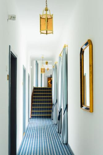 a hallway with blue and white carpeted stairs at Brunnwirt Kassl in Guttaring