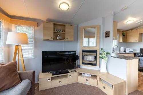 a living room with a large flat screen tv at Inside No 9 Retreat Carnforth in Carnforth