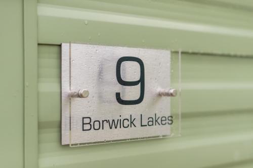 a sign on a door with the number on it at Inside No 9 Retreat Carnforth in Carnforth