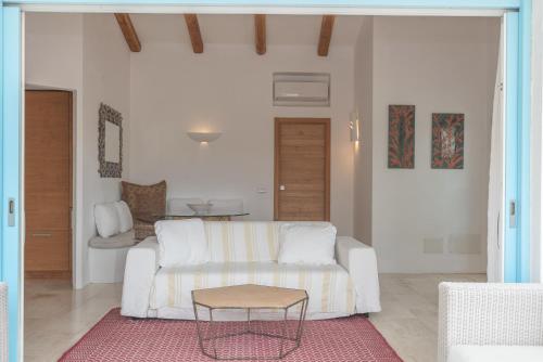 a living room with a white couch and a table at Charming house in San Pantaleo in Olbia