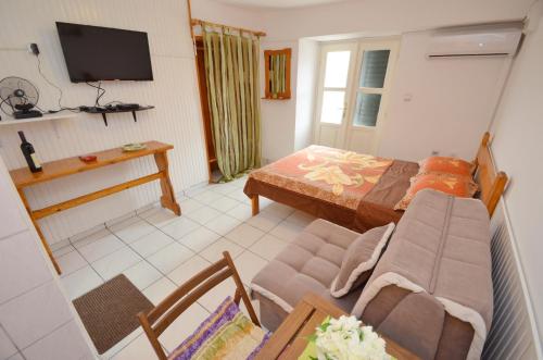 a living room with a bed and a couch at Leut Stone Residence in Tivat