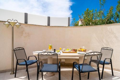 a table and chairs sitting on a patio at Lorena Suite with private pool in Dubrovnik