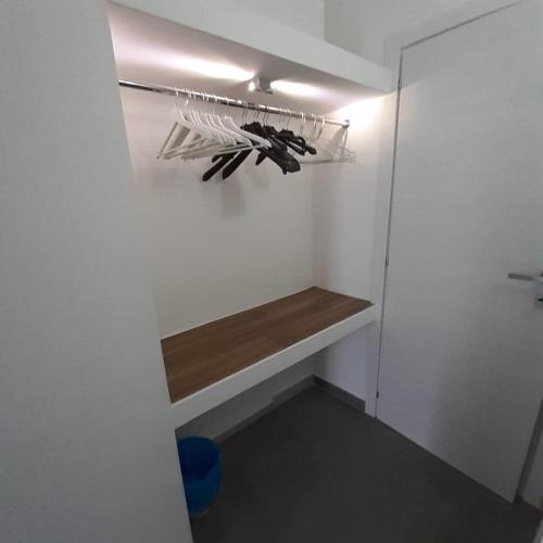 a walk in closet with a shelf in a room at Sweet Suite Margherita in Margherita di Savoia
