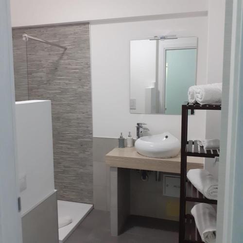a bathroom with a sink and a mirror at Sweet Suite Margherita in Margherita di Savoia