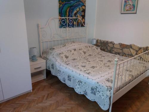 a bedroom with a bed with a white bedspread at Apartment 4988-1 in Pula