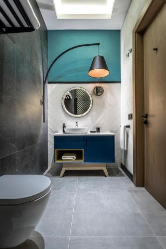 a bathroom with a blue sink and a mirror at PAMPHYLIA HOTEL in Valencia
