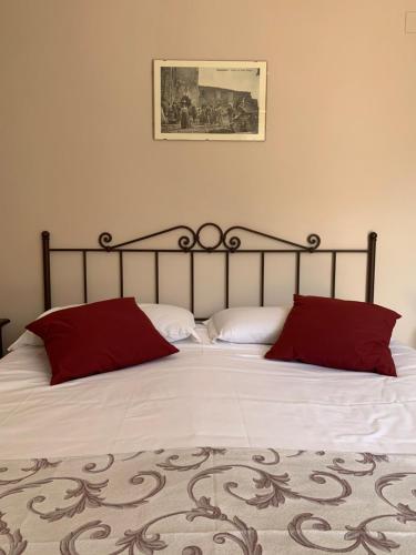 a bedroom with a large bed with red pillows at Casa Vacanze La Villetta in Montefranco