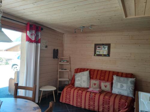 a bedroom with a bed in a room with a table at la ratavelaiza in Champagny-en-Vanoise