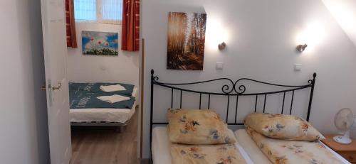 a bedroom with a bed and a crib in a room at Raza Soarelui apartament de lux in Sovata