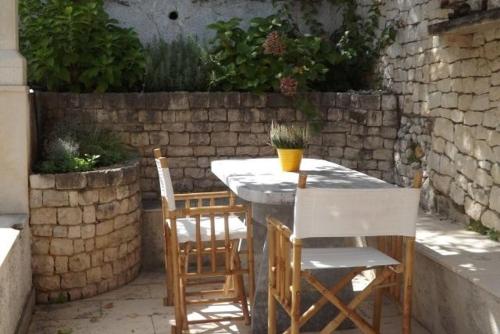 a table and chairs sitting on a patio at Holiday Home with Pool (4298) in Postira