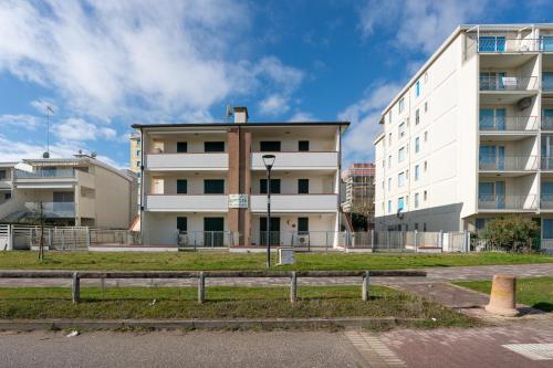 a large white building in front of a building at Smith 3B in Lido degli Estensi