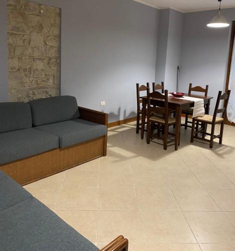 a living room with a couch and a table and chairs at Casa Vacanze La Villetta in Montefranco