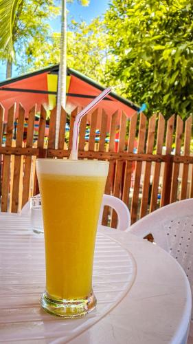 a glass of beer sitting on top of a table at New Breeze Thoddoo Inn in Thoddoo