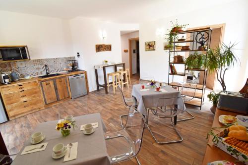 a living room with two tables and a kitchen at Favetto Family Ranch in Rueglio