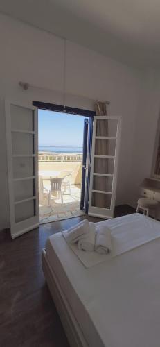a bedroom with a bed and a view of a patio at Frida Village in Hersonissos