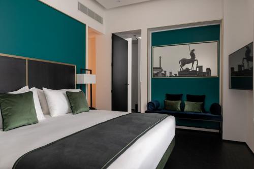 a bedroom with a large bed with green walls at Habita79 Hotel Pompeii - MGallery Collection in Pompei