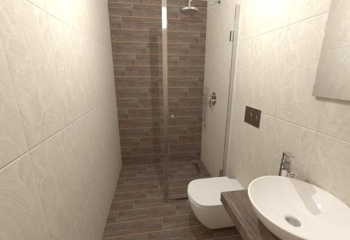 a bathroom with a toilet and a sink and a shower at Fiori Hotel in Gouvia