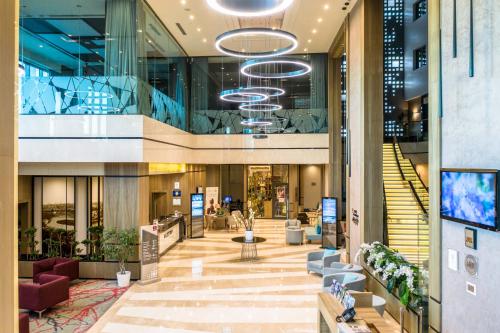 a lobby of a building with escalators and stairs at Clarion Hotel Golden Horn in Istanbul