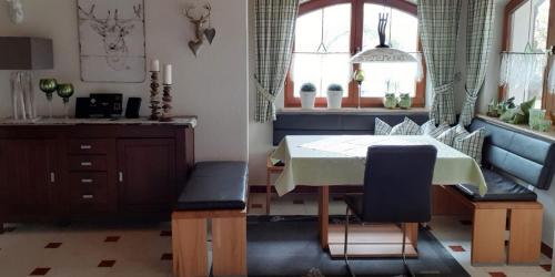 a dining room with a table and two chairs at Ferienwohnung Arberblick in Lam
