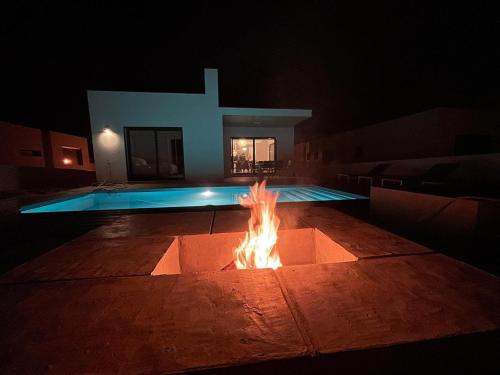 a fire pit in front of a church at night at Cairnvillas: Villa Terra C39 - Luxury Villa with Private Swimming Pool near Beach in Aljezur