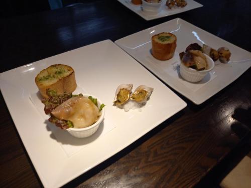 two white plates with different types of food on them at Matsushima Petit Hotel Bistro Abalon in Matsushima