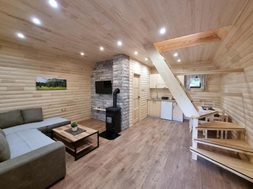 a living room with a couch and a fireplace at Hedonist Village in Žabljak