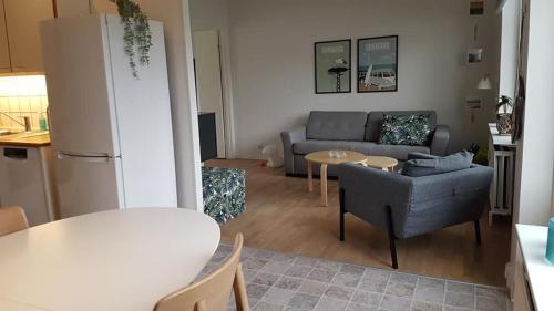 a living room with a couch and a table at Løkken centrum ferielejlighed-apartment 4F in Løkken