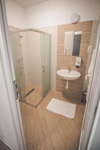 a bathroom with a shower and a sink at Tenisz Panzió - Baja in Baja