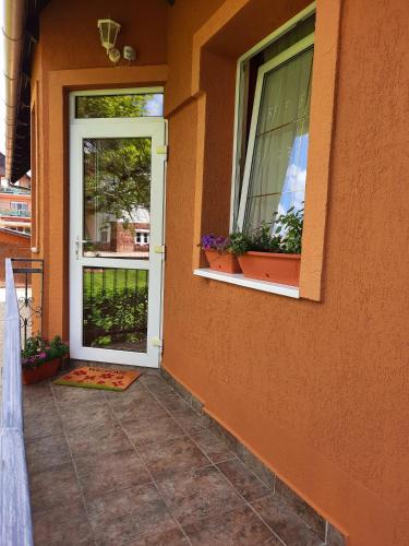 a front door of a house with potted plants at Harmónia Vendégház in Balatonalmádi
