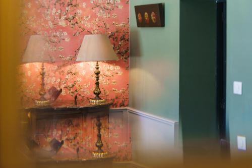 a lamp sitting on a table in a room at Logement Onze Chambres & Gîtes in Raissac-dʼAude
