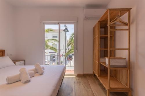 a bedroom with a bed and a book shelf at Wonderful Views Terrace 3BR Cottage - BBQ - AC in Altea