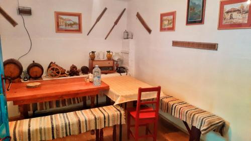 a dining room with a wooden table and chairs at Vila Milenovic Rajacke Pivnice in Rajac
