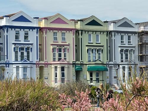 a row of colorful houses on a street at Sunnybeach Holiday Apartments in Paignton