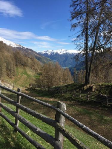a wooden fence with a view of a mountain at Dorfblick Appartements & Rooms in Senales