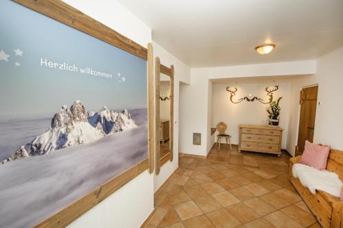 a hallway with a bedroom with a mountain mural on the wall at Mein Alpenstern in Filzmoos