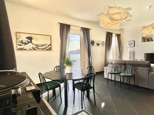 a living room with a table and a couch at Bright Apartment with Sea View Balcony in Salerno