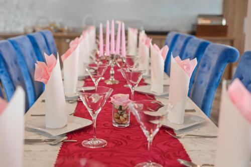 a long table with wine glasses and candles on it at Hotel Prístav in Trstená