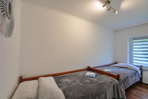 a bedroom with two beds and a window at Willa Białe Tarasy in Krynica Zdrój