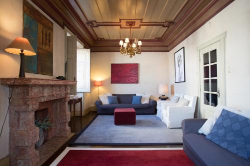 ein Wohnzimmer mit einem Sofa und einem Kamin in der Unterkunft Casa de Santa Teresa in Estoril