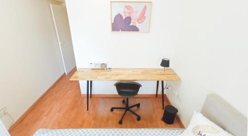 a desk in a room with a chair and a table at 1A BEACH & BUSINESS Apartment in the City CENTER! in Larnaka
