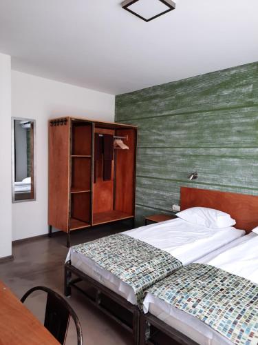 a bedroom with two beds and a green wall at VIDA in Lozenets