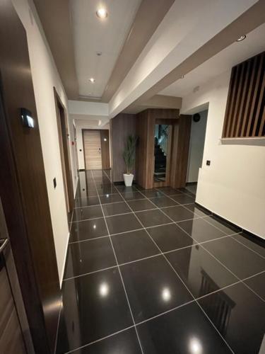 a hallway with a tiled floor in a building at Hotel & Restaurant Ponte Bianco in Vranje