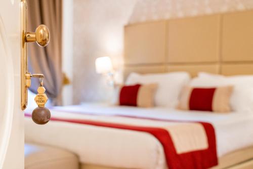 a bedroom with two beds with white and red pillows at Dei Priori Boutique Hotel in Assisi