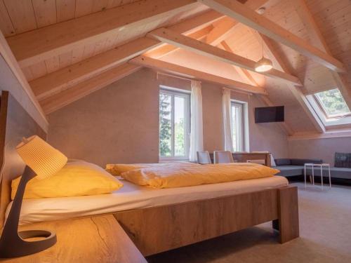 a bedroom with a large bed in a attic at Apartmány Bílá Nisa in Bedřichov
