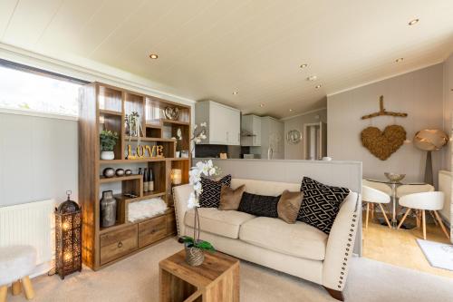 a living room with a couch and a table at Inside No 1 Retreat Carnforth in Carnforth